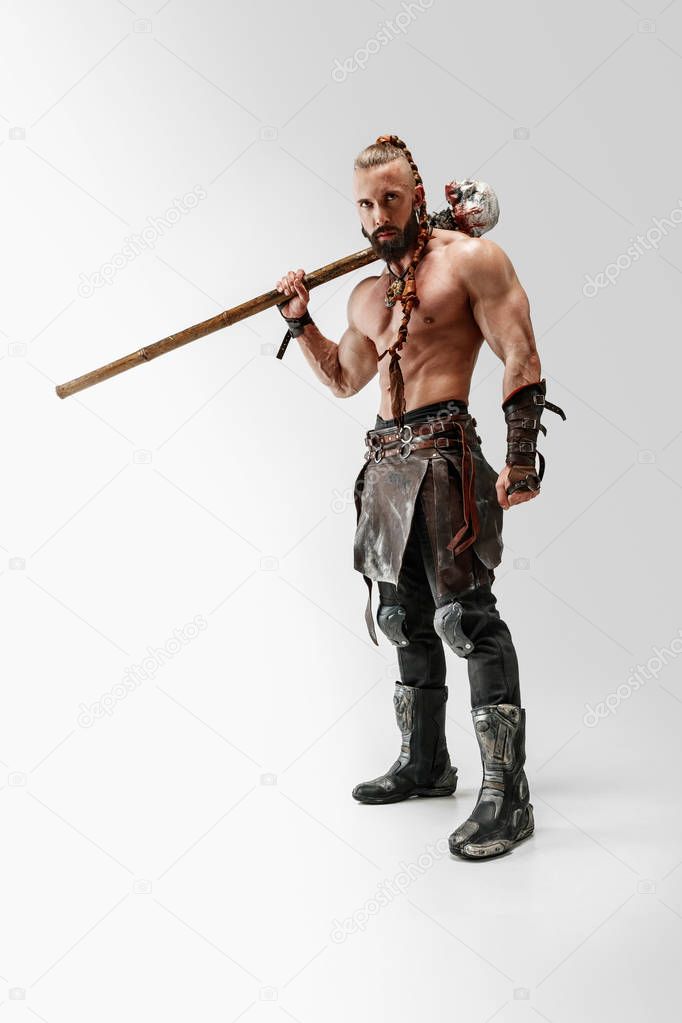 Man in leather vikings costume isolated on white studio background