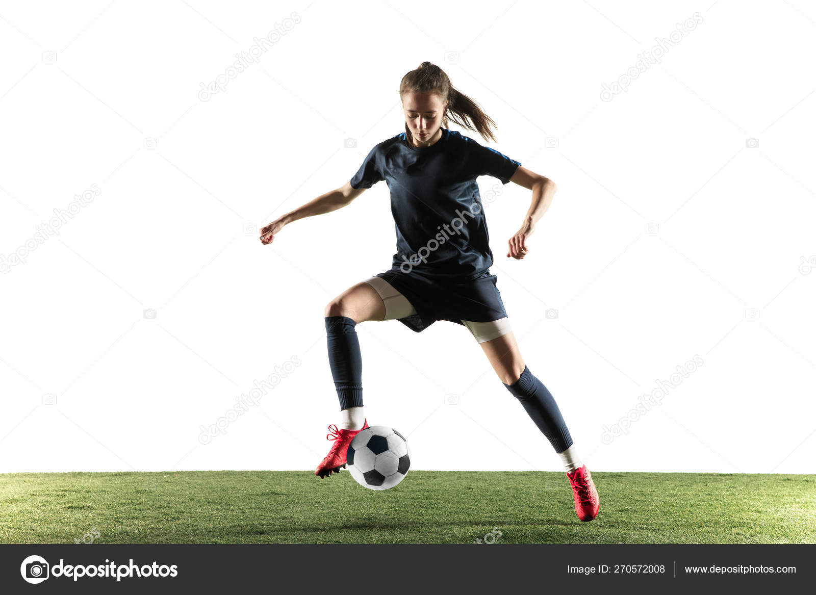 Female soccer player kicking ball isolated over white background Stock Photo by ©vova130555