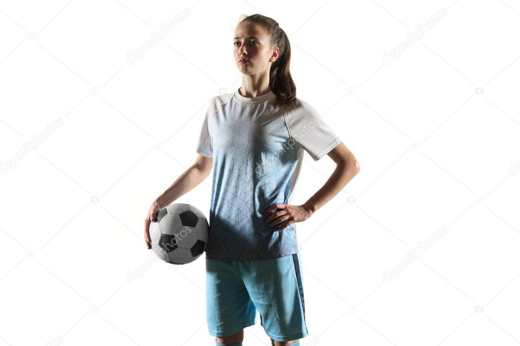 Female soccer player standing with the ball isolated over white background
