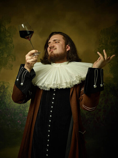 Young man as a medieval knight on dark background