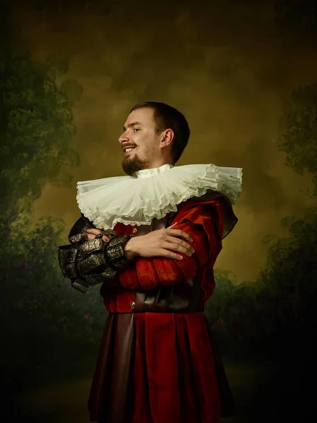 Young man as a medieval knight on dark background — Stock Photo, Image