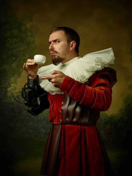 Young man as a medieval knight on dark background — Stock Photo, Image