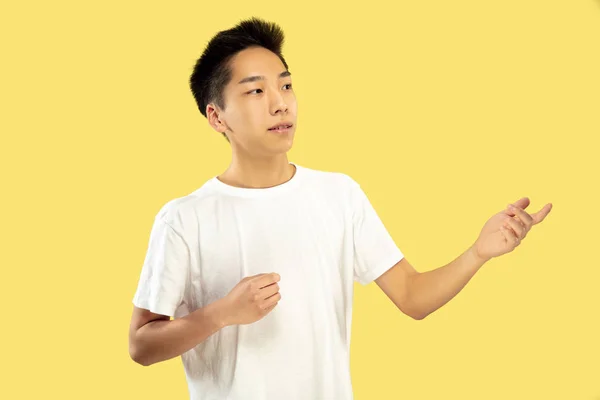 Korean young man's half-length portrait on yellow background — Stock Photo, Image