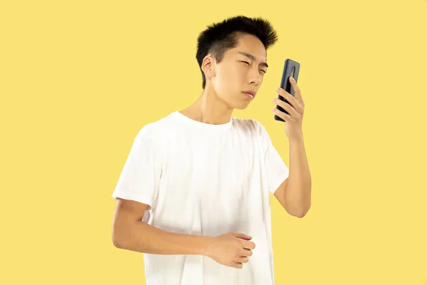 Portrait mi-long du jeune homme coréen sur fond jaune — Photo