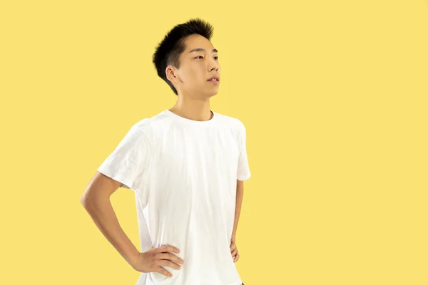 Korean young man's half-length portrait on yellow background — Stock Photo, Image