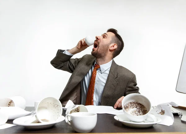 Young man drinking a lot of coffee