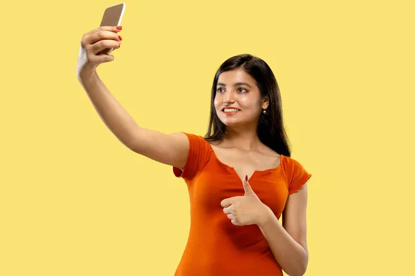 Portrait of beautiful woman isolated on yellow studio background — Stock Photo, Image