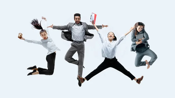 Office workers jumping isolated on studio background — Stock Photo, Image