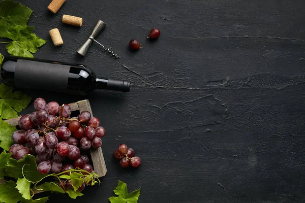 Vista superior de sabroso plato de frutas con la botella de vino en la piedra negra — Foto de Stock