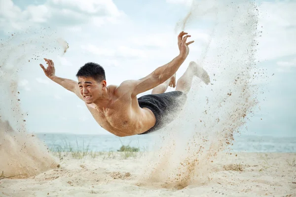 Młody człowiek zdrowy zawodnik robi przysiady na plaży — Zdjęcie stockowe