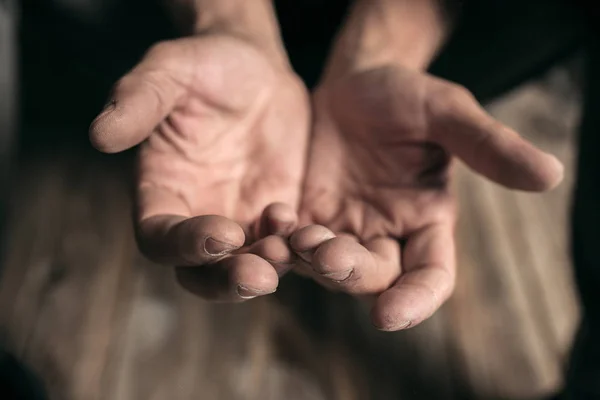 Male beggar hands seeking money on the wooden floor at public path way — Stock Photo, Image