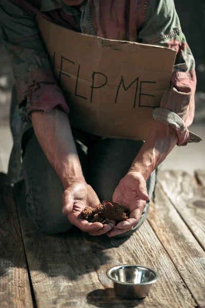 Male beggar hands seeking money on the wooden floor at public path way — Stock Photo, Image