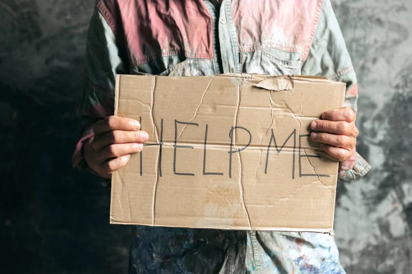 Male beggar hands seeking money on the wooden floor at public path way