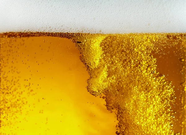 Close up view of floating bubbles in light beer texture