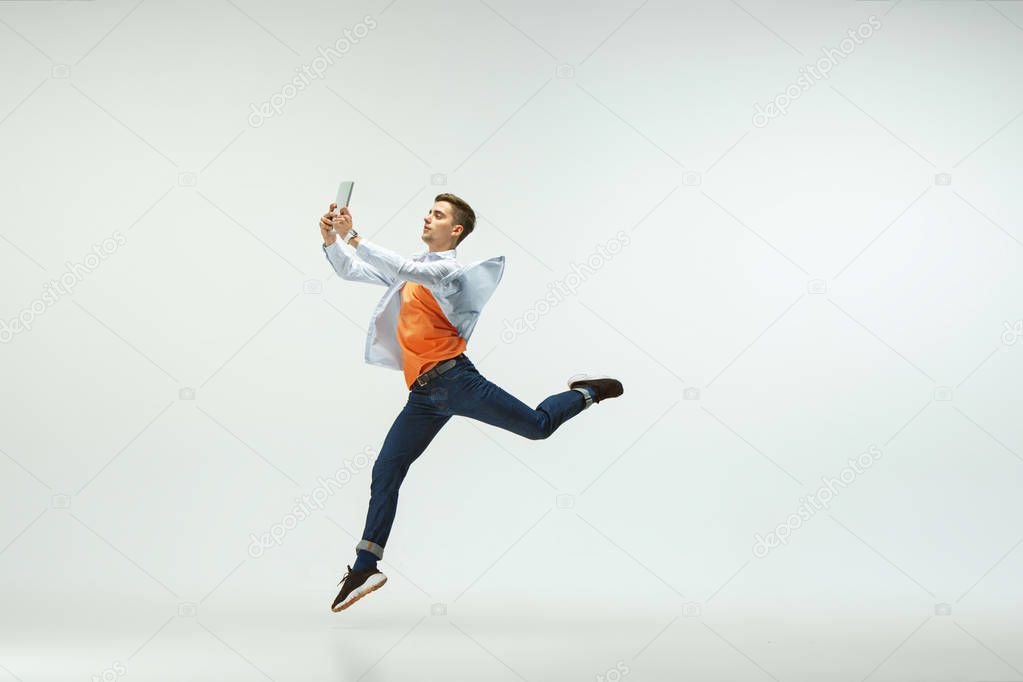 Man working at office and jumping isolated on studio background