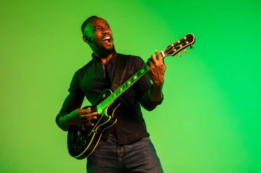 Young african-american jazz musician playing the guitar clipart