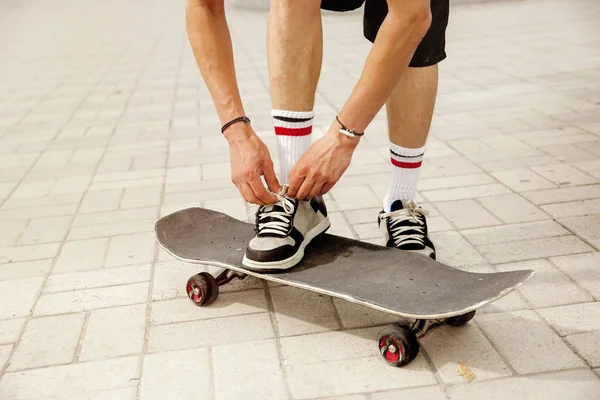 Skateboarder at the citys street in cloudly day