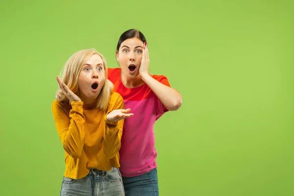 Portrait of pretty girls isolated on green studio background — Stock Photo, Image