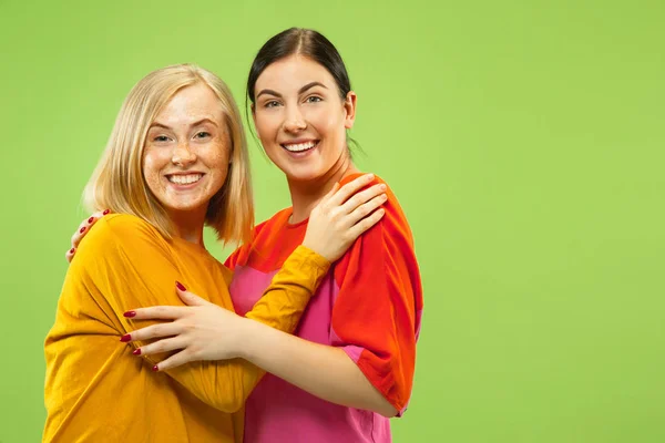 Portrait of pretty girls isolated on green studio background — Stock Photo, Image