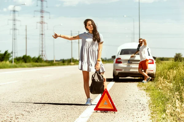 Casal jovem viajando no carro em dia ensolarado — Fotografia de Stock