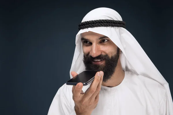 Hombre saudí árabe sobre fondo de estudio azul oscuro — Foto de Stock