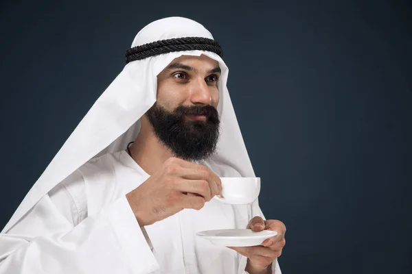 Hombre saudí árabe sobre fondo de estudio azul oscuro — Foto de Stock