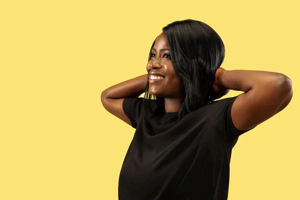 Young african woman isolated on yellow studio background, facial expression — Stock Photo, Image