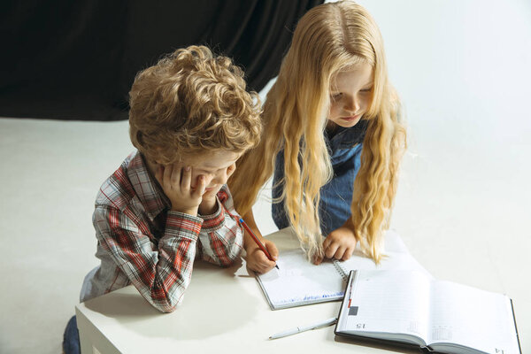 Boy and girl preparing for school after a long summer break. Back to school.