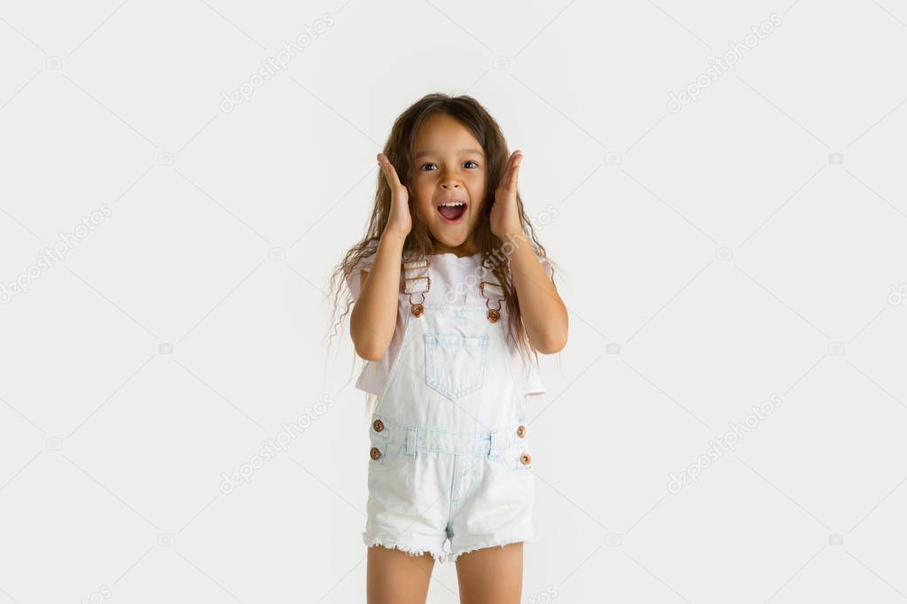 Portrait of little girl isolated on white studio background