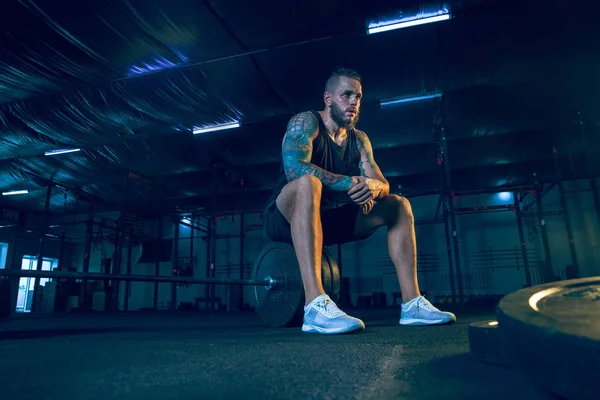 Genç sağlıklı erkek atlet spor salonunda eğitim için hazırlanıyor