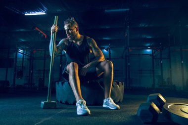 Genç sağlıklı erkek atlet spor salonunda egzersiz yapıyor