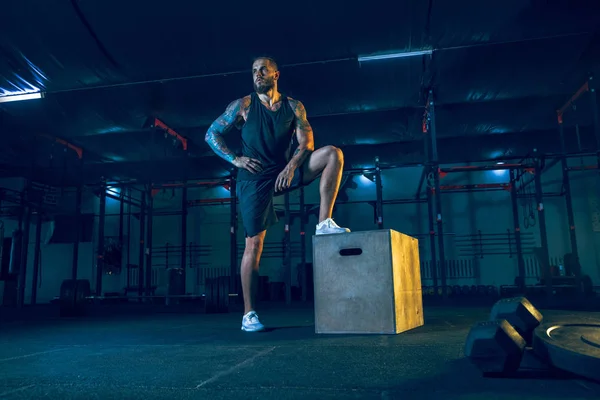 Joven atleta hombre sano haciendo ejercicio en el gimnasio — Foto de Stock