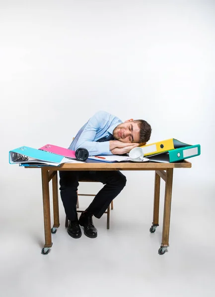 Den unge mannen är skamlöst sover på skrivbordet under sin arbetstid — Stockfoto