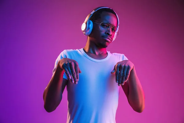 Jóvenes afroamericanos escuchando música a la luz de neón — Foto de Stock