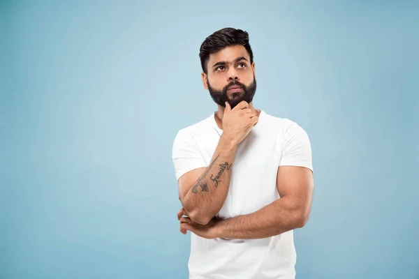 Half-length close up portrait of young man on blue background. — Stock Photo, Image