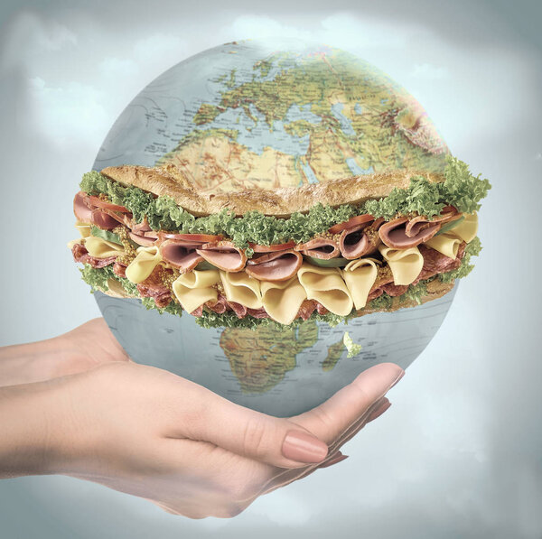 Save healthy food - female hands holding a globe as a sandwich
