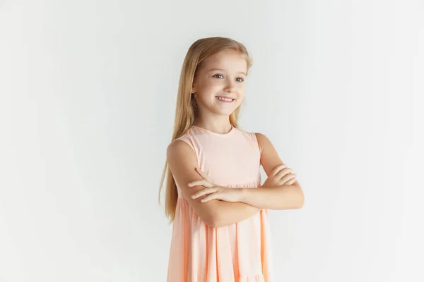 Little smiling girl posing in dress on white studio background — Stock Photo, Image