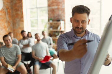 Üniversite atölyesinde salonda sunum yapan erkek konuşmacı
