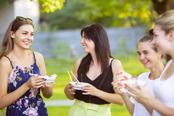 Happy friends eating at barbecue dinner on sunset time — Stock Photo, Image