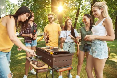 Mutlu arkadaşlar güneşli bir günde bira ve barbekü partisi yapıyoruz