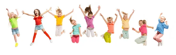 Group of elementary school kids jumping, back to school — Stock Photo, Image