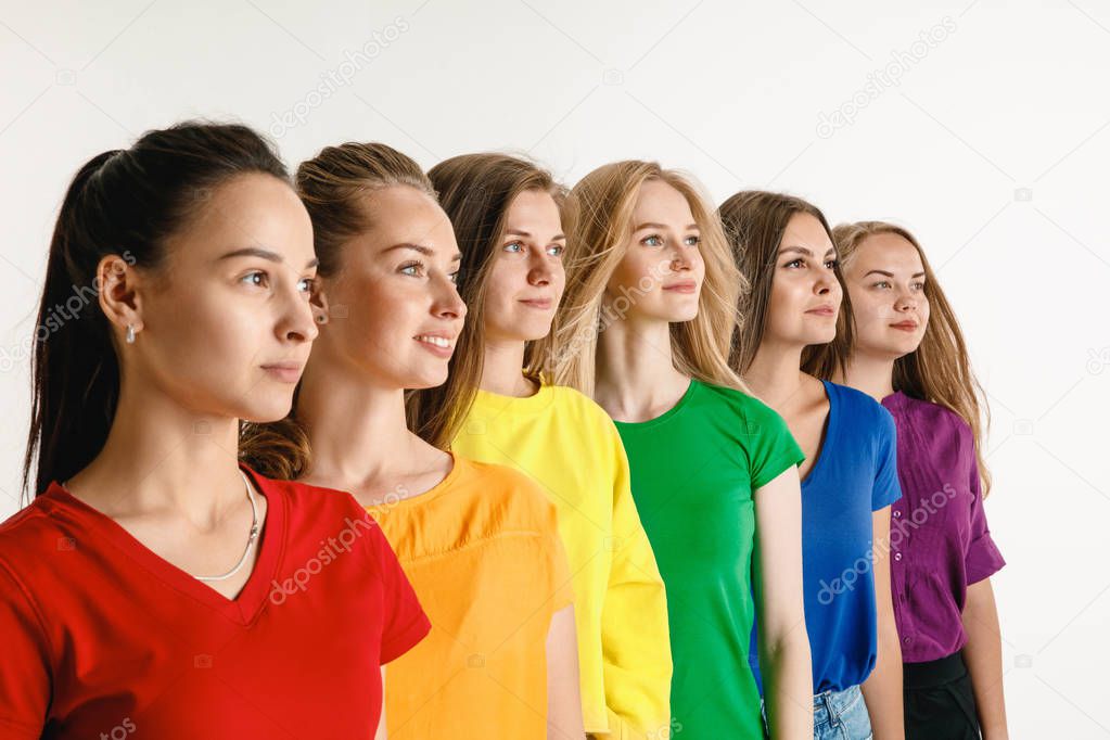 Young women weared in LGBT flag colors isolated on white background, LGBT pride concept