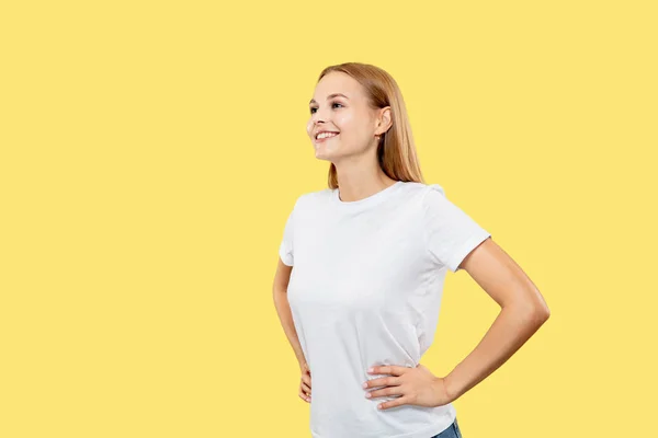 Caucasian young womans half-length portrait on yellow background — Stock Photo, Image