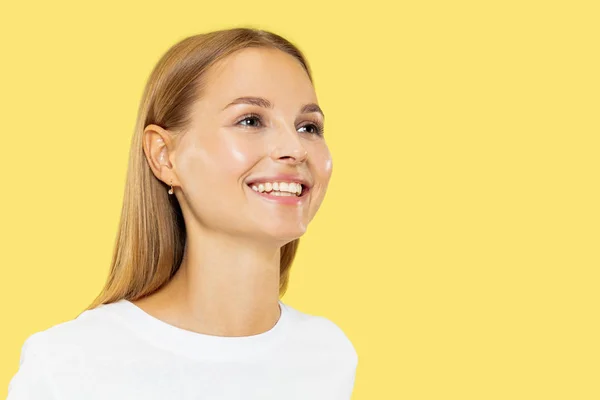 Caucasian young womans half-length portrait on yellow background — Stock Photo, Image