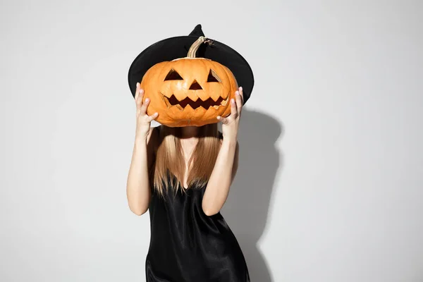Young woman in hat as a witch on white background — Stock Photo, Image