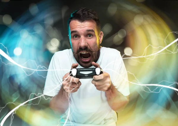 Enthusiastic gamer. Joyful young man holding a video game controller — Stock Photo, Image