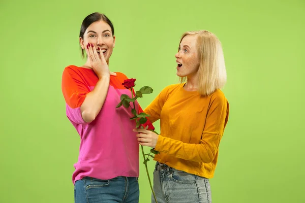 Portrait of pretty girls isolated on green studio background — Stock Photo, Image