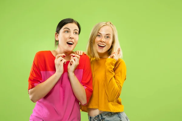 Portrait of pretty girls isolated on green studio background — Stock Photo, Image