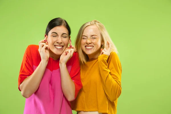 Portret van mooie meisjes geïsoleerd op groene studio achtergrond — Stockfoto