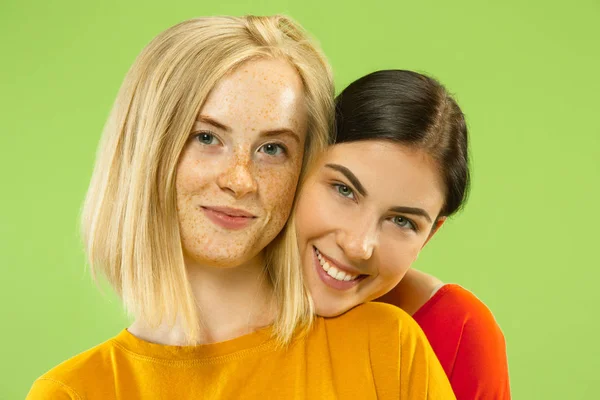 Portrait of pretty girls isolated on green studio background — Stock Photo, Image